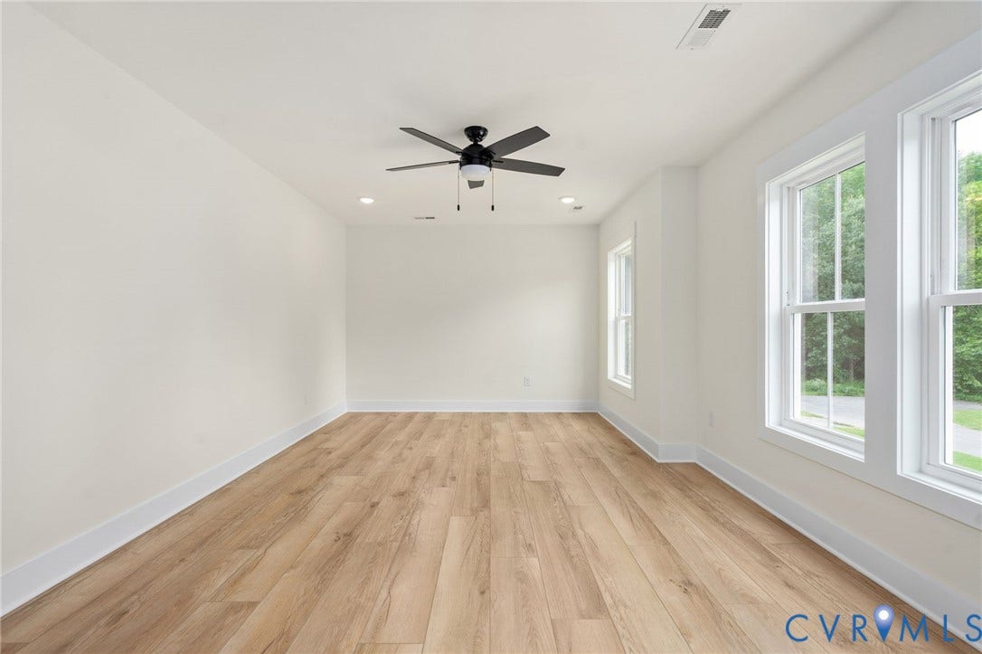 7603 Oster Drive, Chamberlayne Farms Area, Henrico, VA 23227 Wood-finish flooring, recessed lighting, ceiling fan with light fixture, multiple windows with white trim, and neutral wall paint