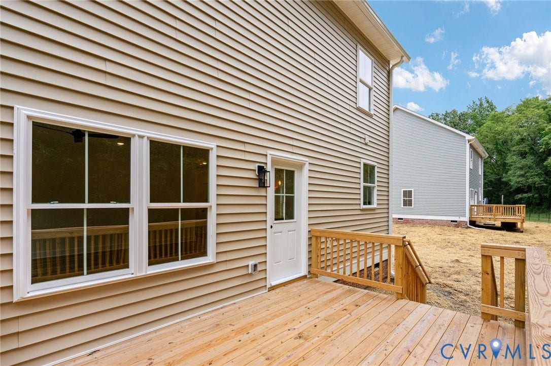 7603 Oster Drive, Chamberlayne Farms Area, Henrico, VA 23227 Exterior featuring tan siding, a wooden deck with railing, and white-framed windows