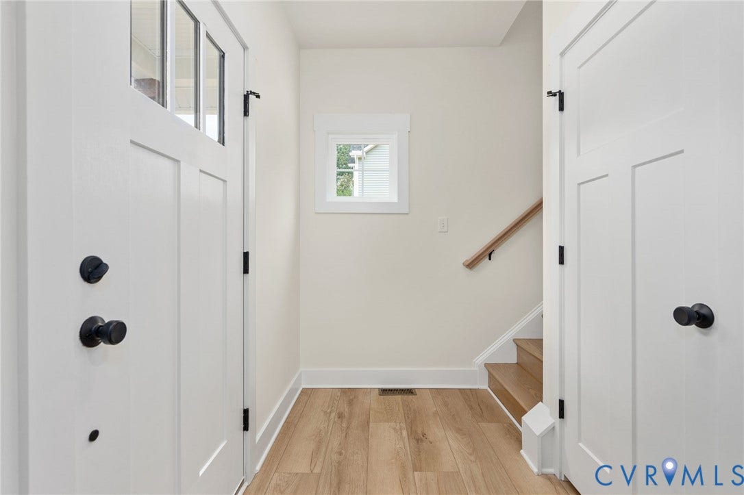 7603 Oster Drive, Chamberlayne Farms Area, Henrico, VA 23227 White paneled doors with black hardware, wood-finish flooring, white window trim, and a wood handrail