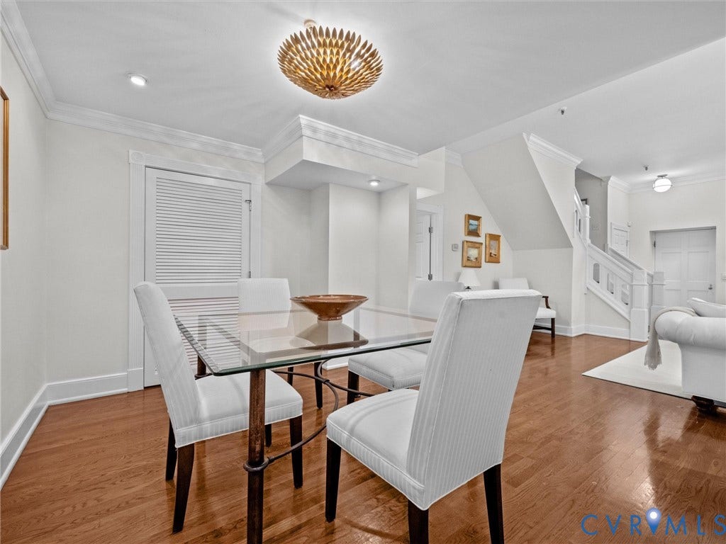 Hardwood flooring, crown molding, recessed lighting, and a decorative ceiling fixture