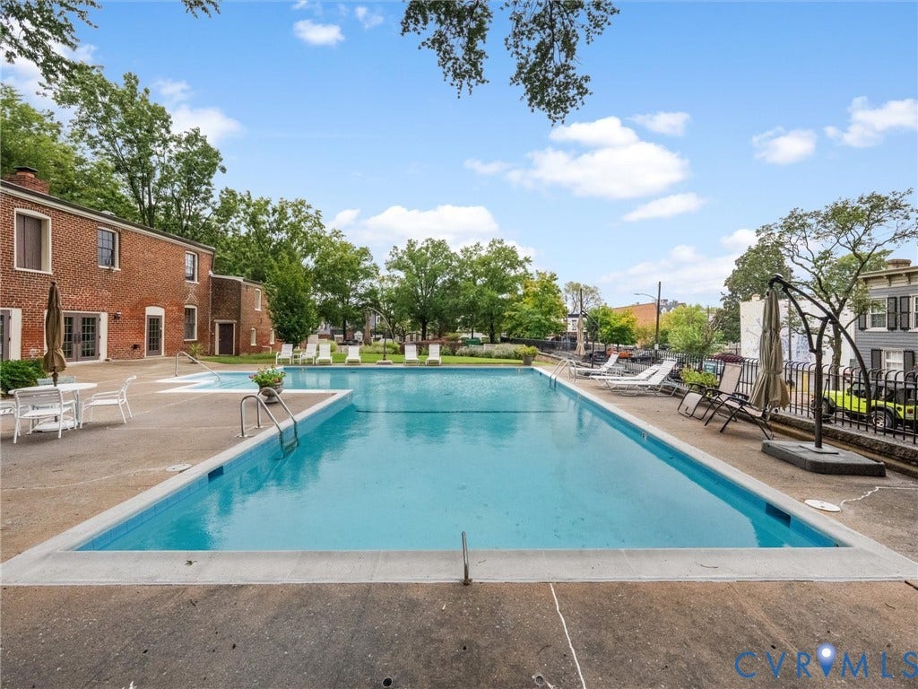 Expansive outdoor swimming pool with surrounding concrete decking