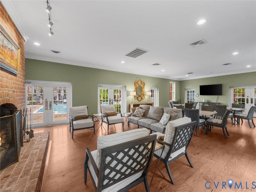 Hardwood-finish flooring throughout, recessed lighting, and a brick fireplace