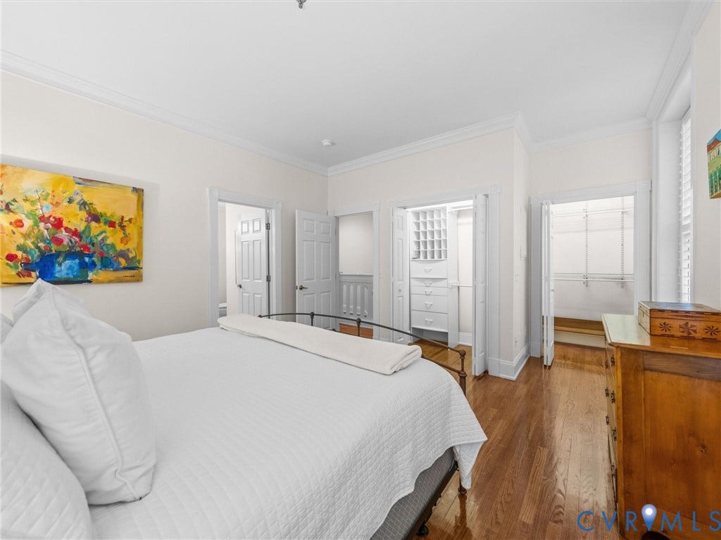 Wood-finish flooring, crown molding, and two built-in closet systems