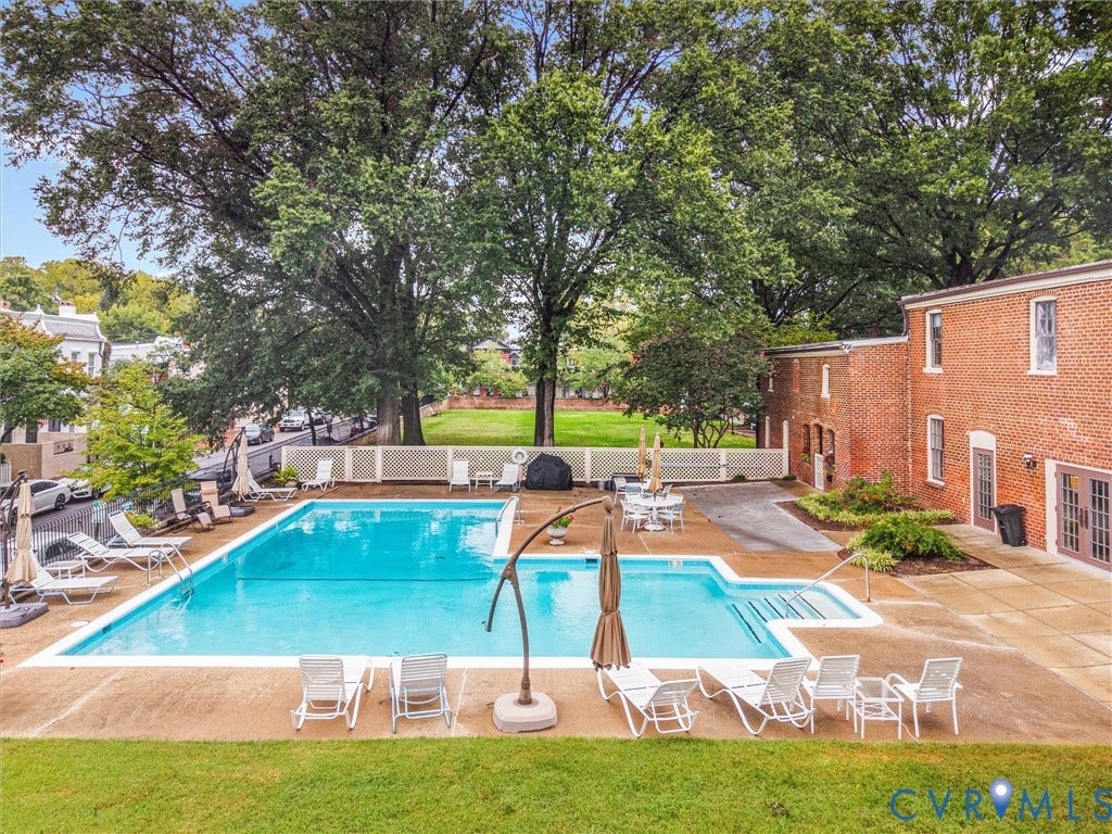 Outdoor swimming pool with integrated steps, surrounded by a concrete patio