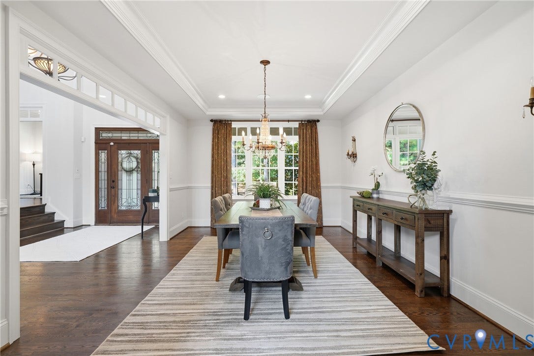 Large formal dining room with hardwood floors and recessed lighting