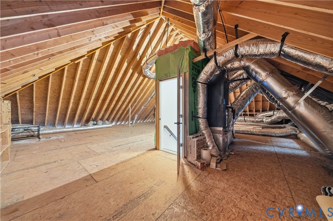 Walk-up attic with exposed roof framing and additional space for household storage