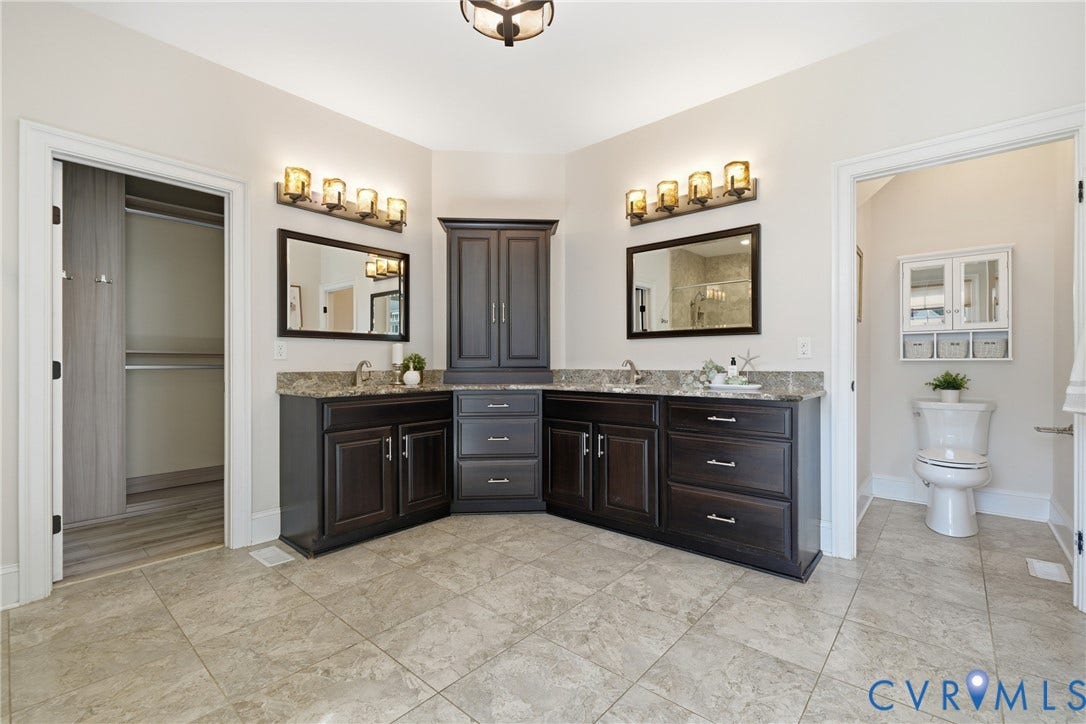 Freshly painted ensuite (2026) featuring dual vanities and water closet