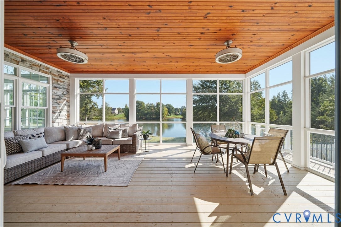 Inviting outdoor living space with a rich wood ceiling and a front-row view of the pond.