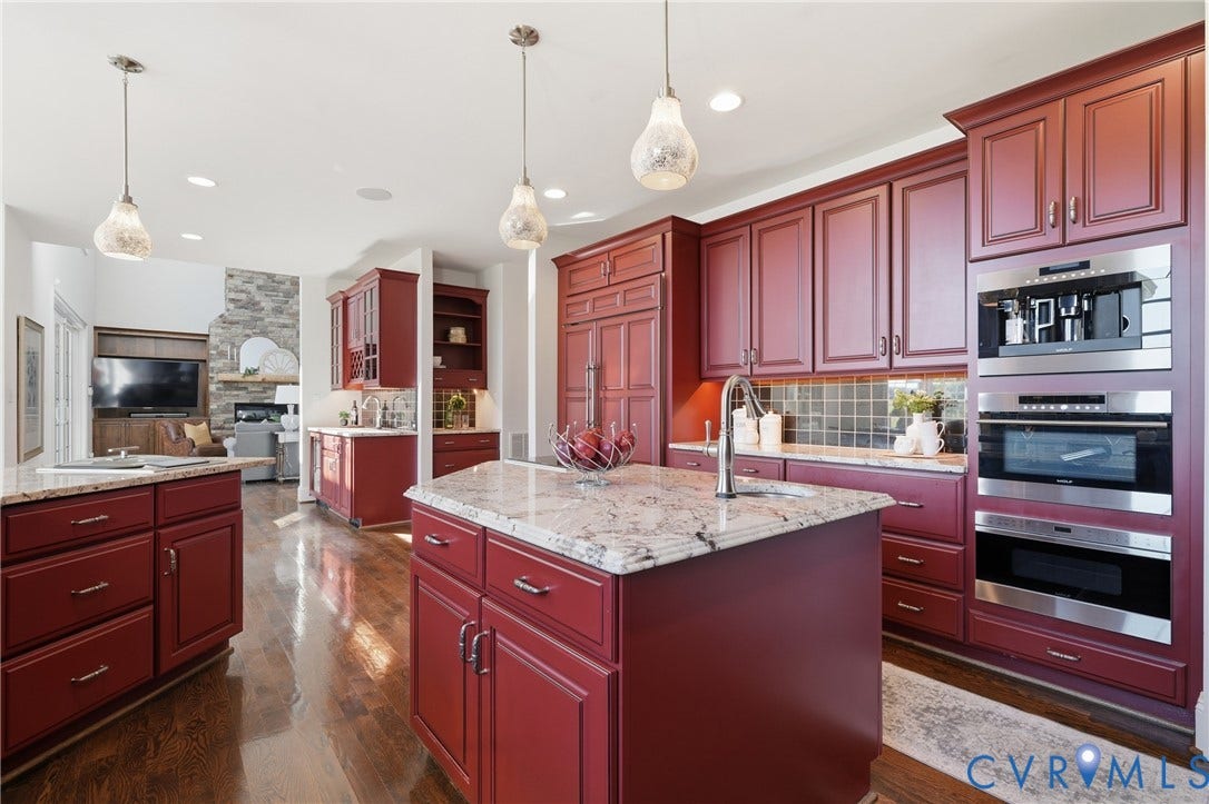Well appointed kitchen with Wolf wall ovens, gas range, induction cooktop and built-in steamer preparation.