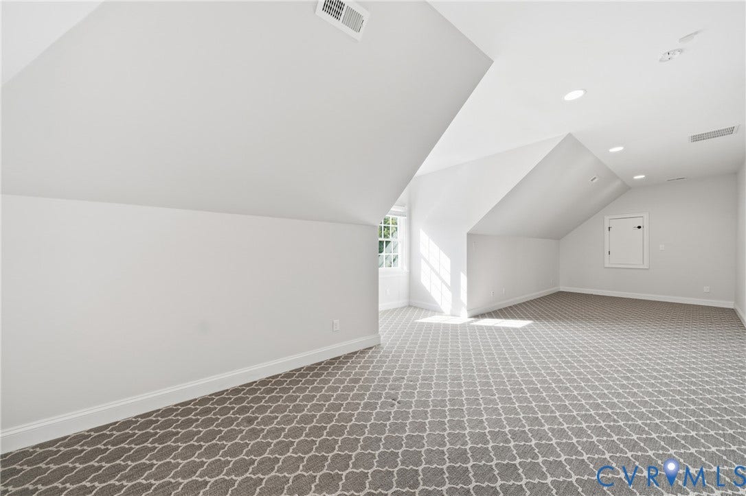 Upper-level bedroom with recessed lighting and large storage space