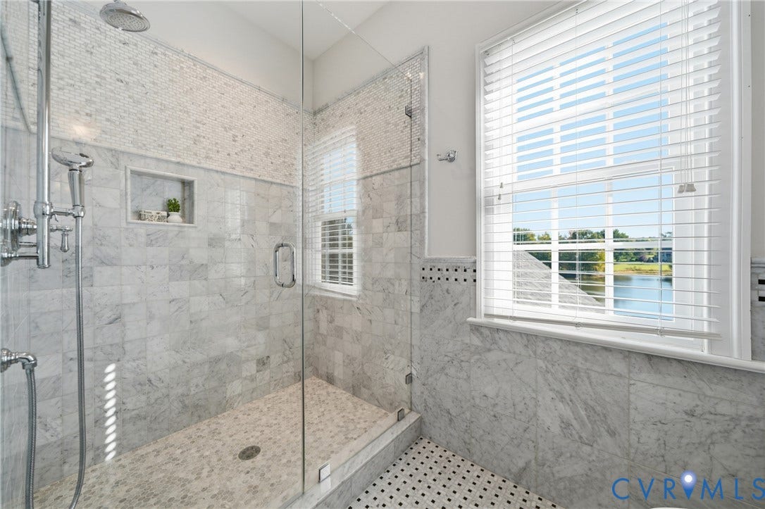 Ensuite bathroom with glass shower and waterfront views