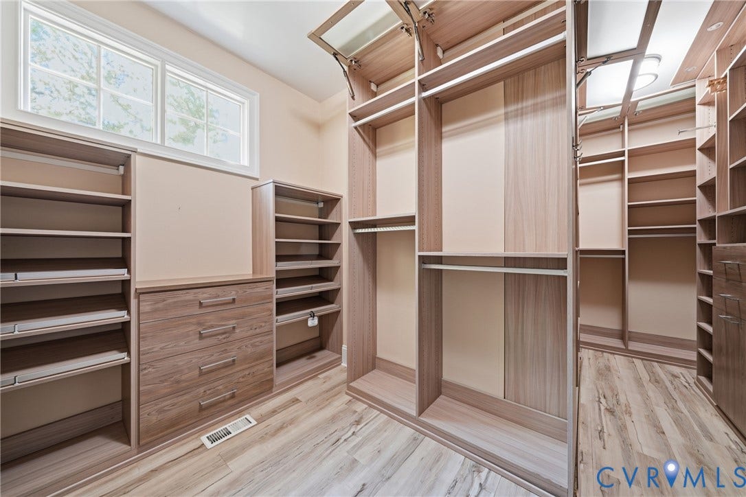 Thoughtfully designed primary walk-in closet with tailored storage