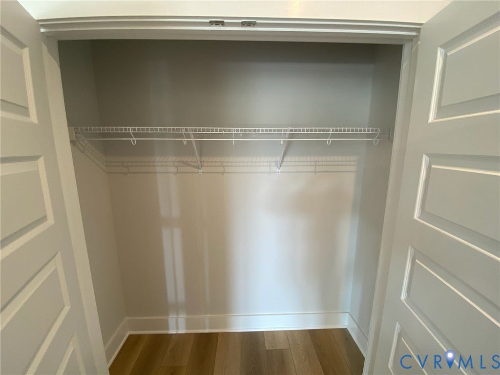 2701 St Elias Drive, #B, Richmond, VA 23294 Recessed closet with white wire shelving, wood-finish flooring, and panel doors