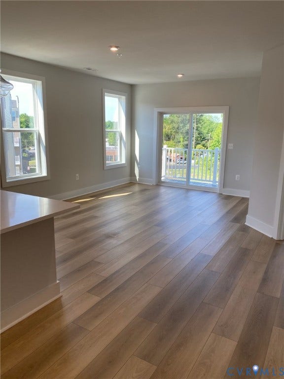 2701 St Elias Drive, #B, Richmond, VA 23294 Wood-finish flooring, recessed lighting, double windows, and a sliding glass door opening to a balcony