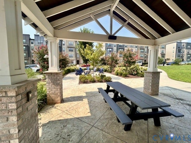 2701 St Elias Drive, #B, Richmond, VA 23294 Covered outdoor pavilion with exposed beam ceiling, brick-clad columns, and stamped concrete flooring