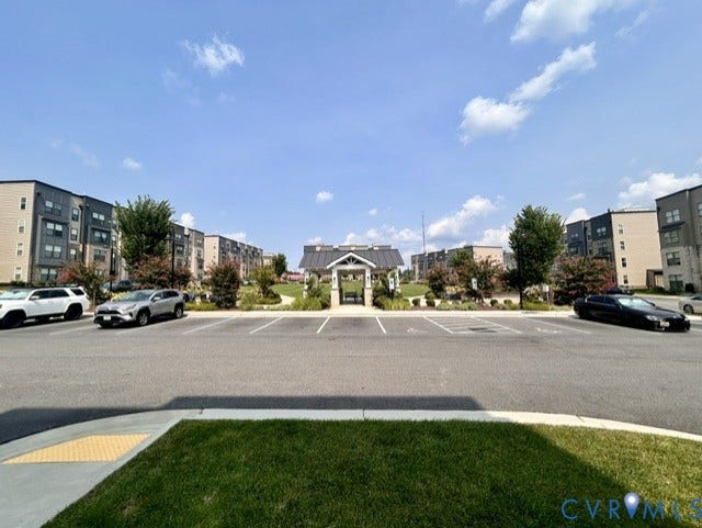 2701 St Elias Drive, #B, Richmond, VA 23294 Paved parking area featuring striped parking spaces