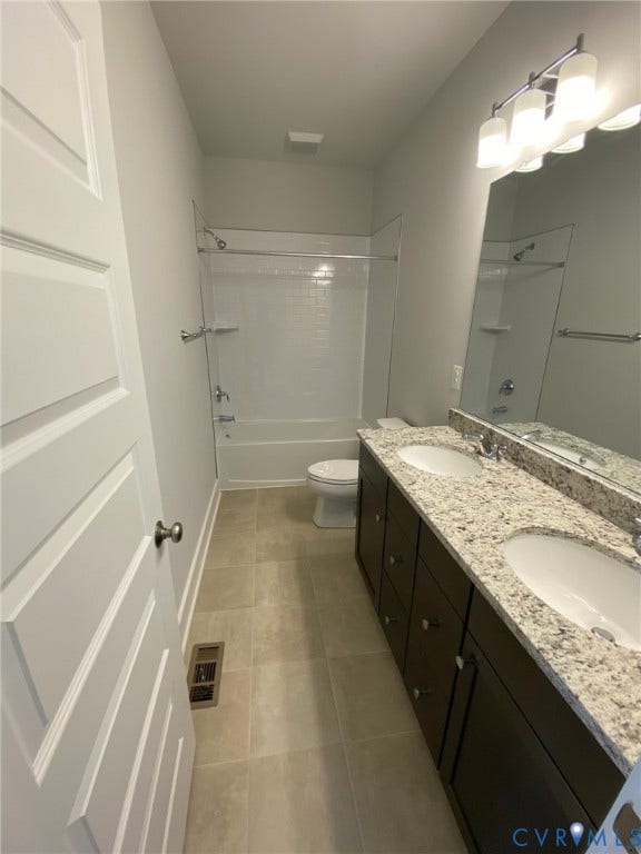 2701 St Elias Drive, #B, Richmond, VA 23294 Dual sink vanity with stone-finish countertop, dark wood-finish cabinetry, and tiled flooring