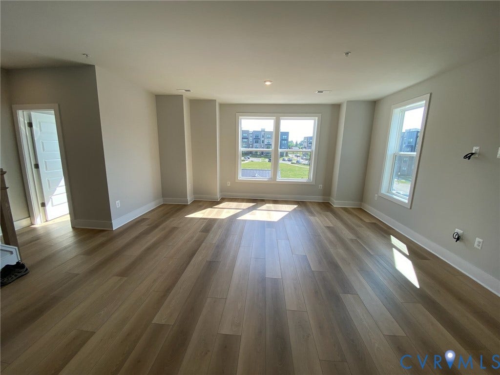 2701 St Elias Drive, #B, Richmond, VA 23294 Spacious room with wood-finish flooring, recessed lighting, and multiple windows