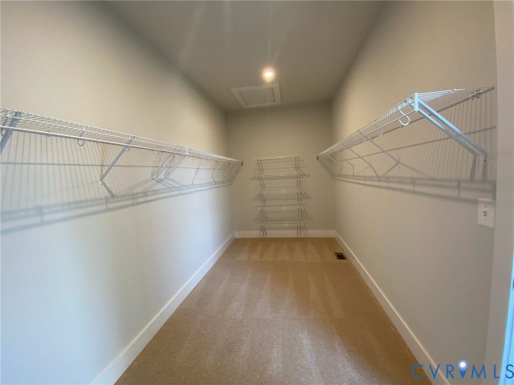 2701 St Elias Drive, #B, Richmond, VA 23294 Spacious walk-in closet featuring wire shelving, wire basket storage, and carpet flooring