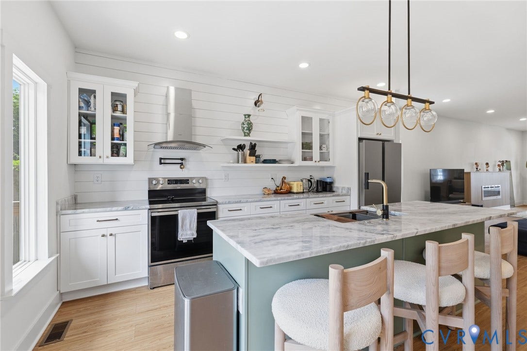 2506 Porter Street, Richmond, VA 23225 Kitchen featuring white shaker cabinetry, stainless steel appliances, a large center island with counter seating, light-toned wood-finish flooring, and recessed ceiling lighting