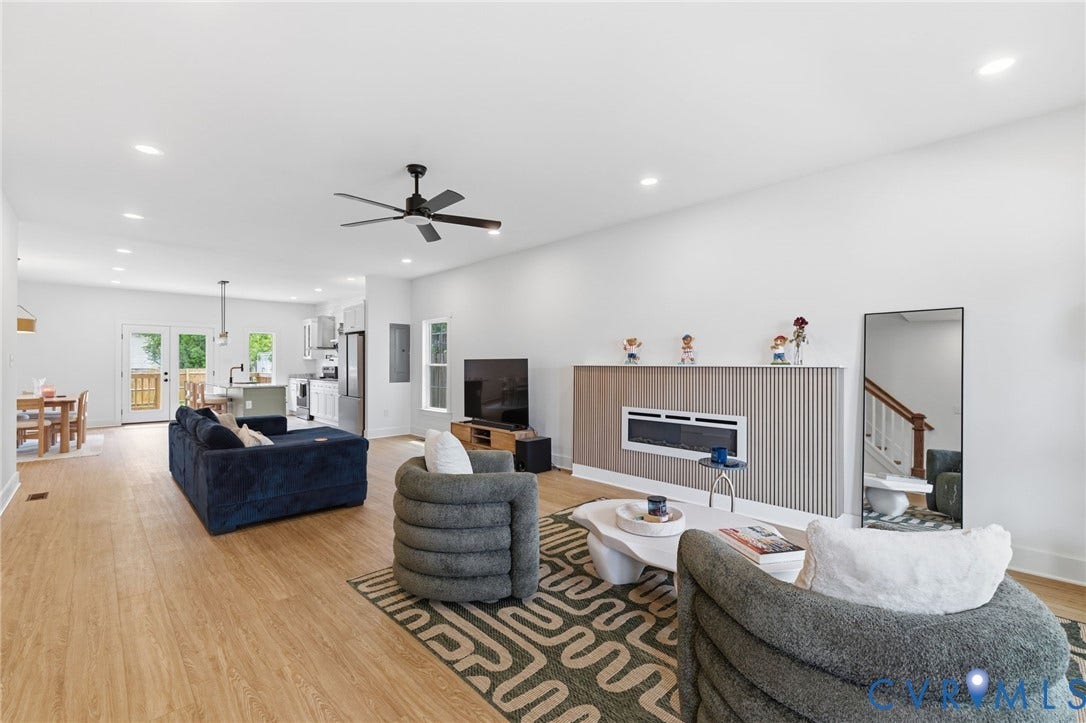 2506 Porter Street, Richmond, VA 23225 Spacious living area featuring light wood-finish flooring, recessed lighting, and a contemporary fireplace with a slatted surround