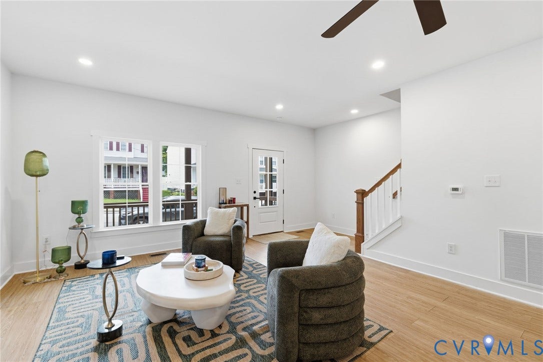 2506 Porter Street, Richmond, VA 23225 Bright living area featuring wood-finish flooring, recessed lighting, and a prominent staircase with wood railing