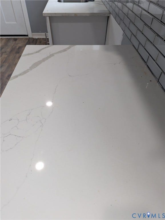 4202 Chamberlayne Avenue, Richmond, VA 23227 White countertop with veining, subway tile backsplash, and wood-finish flooring