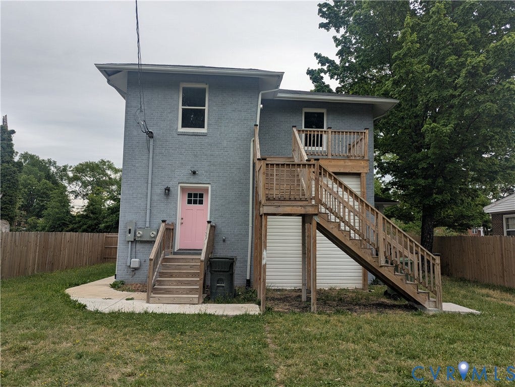4202 Chamberlayne Avenue, Richmond, VA 23227 Exterior featuring a light gray facade, a pink entry door with multiple window panes, two multi-level wood decks, and a perimeter wood fence