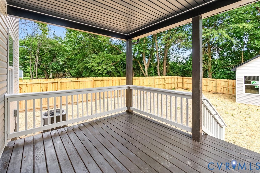 1146 Willcox Street, Petersburg, VA 23803 Covered wood-finish deck with white railing and dark support beams