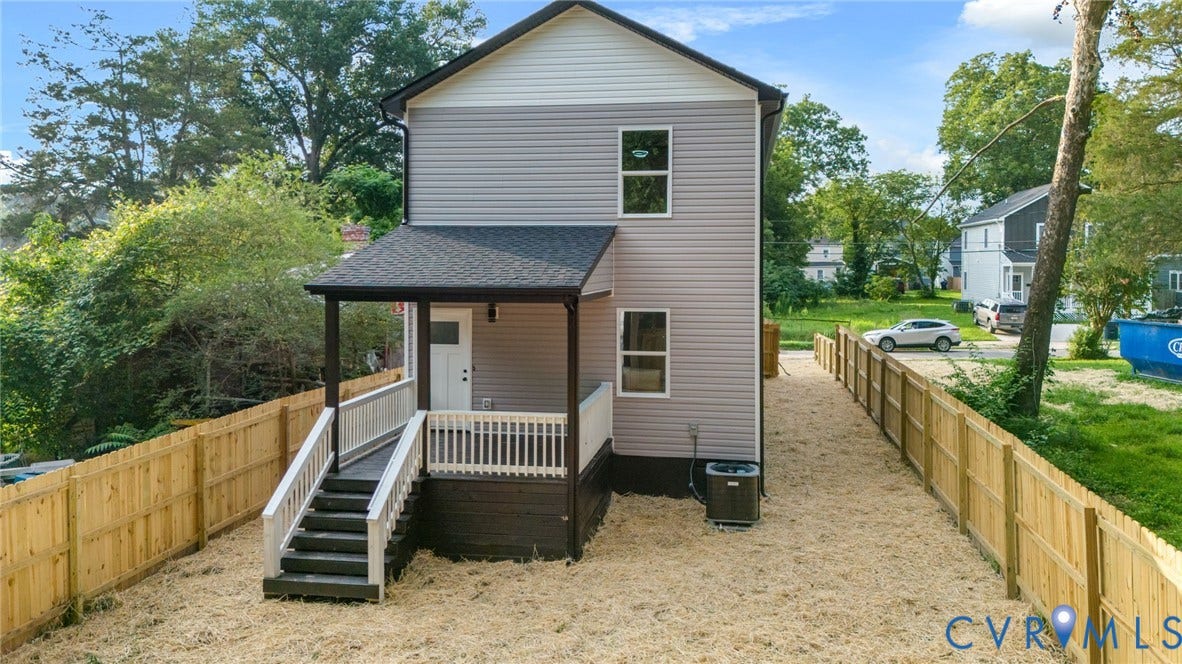 1146 Willcox Street, Petersburg, VA 23803 Rear exterior featuring light grey siding, a covered porch with white railings, and a dark grey shingled roof