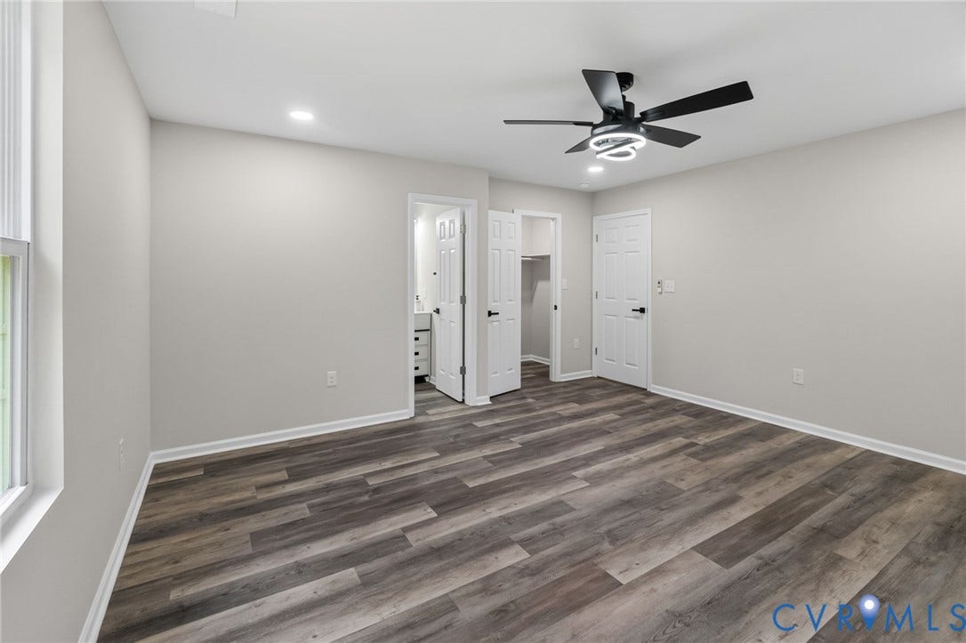 1146 Willcox Street, Petersburg, VA 23803 Spacious room featuring wood-finish flooring, light gray walls, white trim, a modern black ceiling fan with integrated lighting, and recessed ceiling lights