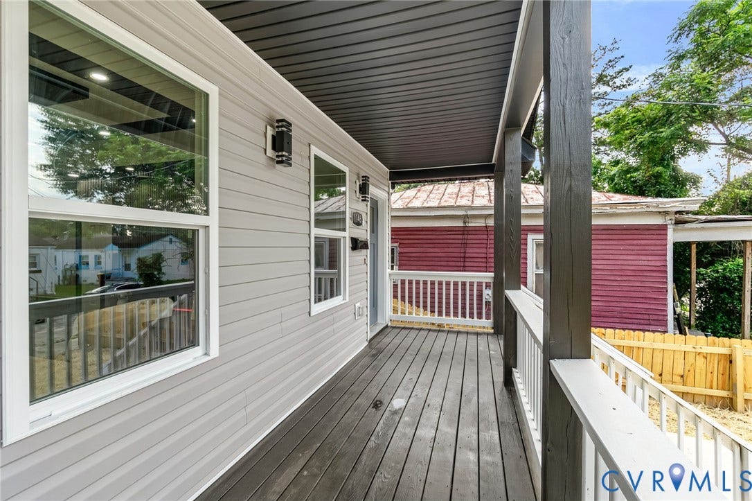 1146 Willcox Street, Petersburg, VA 23803 Covered porch featuring dark wood-finish flooring, white railing, and a gray siding exterior
