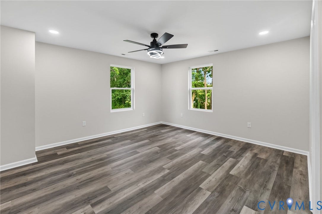1146 Willcox Street, Petersburg, VA 23803 Spacious room featuring wood-finish flooring, light gray wall tones, and white trim