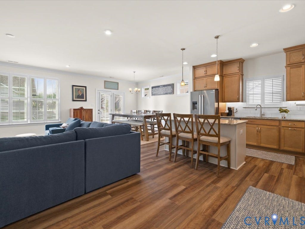 1801 Outrigger Drive, Meadowville Landing, Chesterfield, VA 23836 Open-concept living space featuring wood-finish flooring, recessed lighting, and white plantation shutters