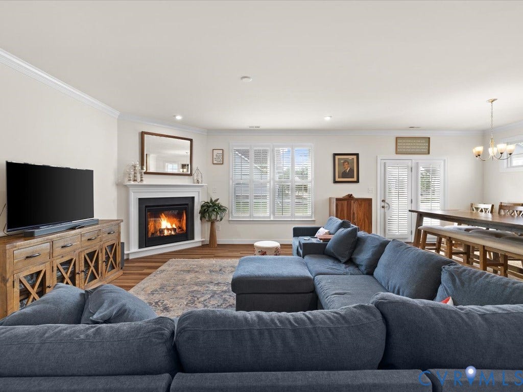 1801 Outrigger Drive, Meadowville Landing, Chesterfield, VA 23836 Built-in fireplace with a white mantel, wood-finish flooring, white plantation shutters, and recessed lighting