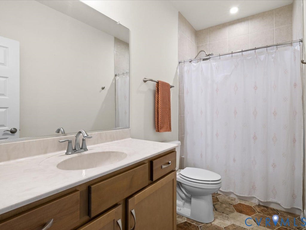 1801 Outrigger Drive, Meadowville Landing, Chesterfield, VA 23836 Bathroom featuring a wood-finish vanity with an integrated sink and light-toned countertop