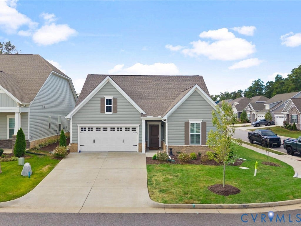 1801 Outrigger Drive, Meadowville Landing, Chesterfield, VA 23836 Siding exterior with stone accenting, an attached two-car garage, and a concrete driveway