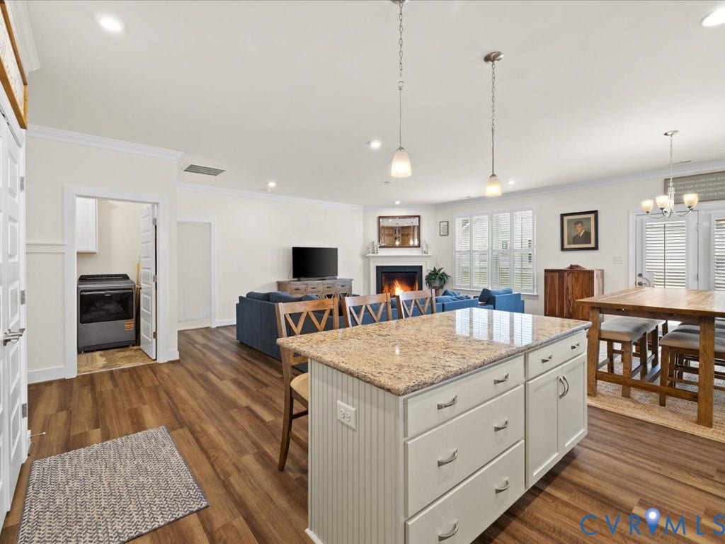 1801 Outrigger Drive, Meadowville Landing, Chesterfield, VA 23836 Kitchen island with a granite-style countertop, recessed lighting, wood-finish flooring, white cabinetry, and a built-in fireplace