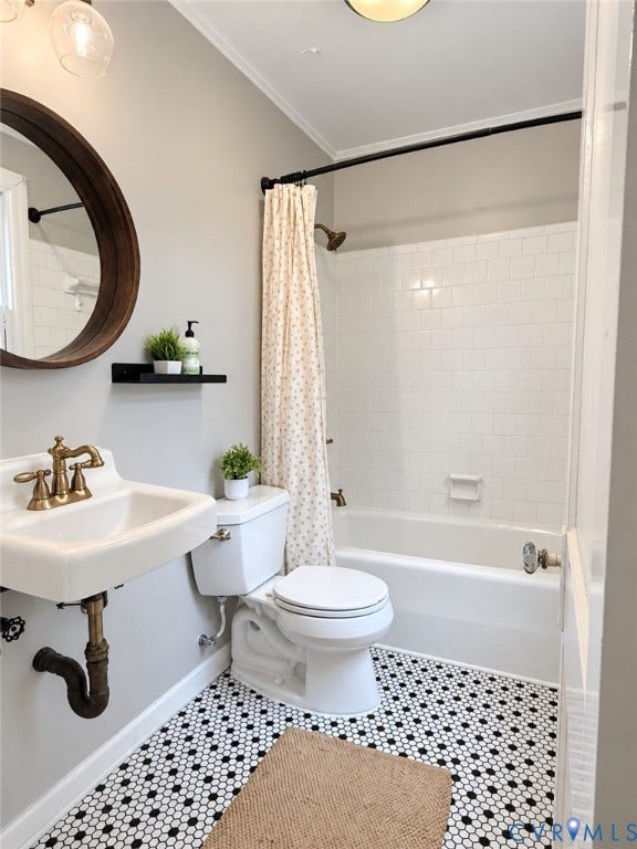 518 Central Terrace, Hopewell, VA 23860 Pedestal sink with brass-finish faucet, hexagonal floor tiling, and a built-in tub with subway tile surround