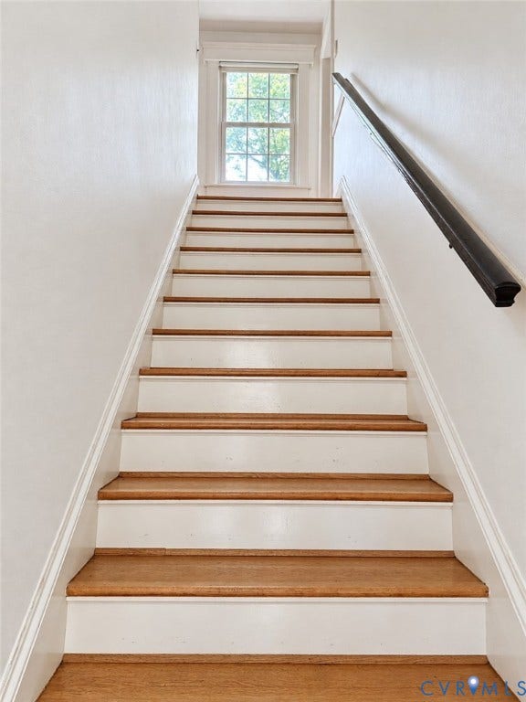 518 Central Terrace, Hopewell, VA 23860 Staircase featuring wood-finish treads, white risers, and a black wall-mounted handrail