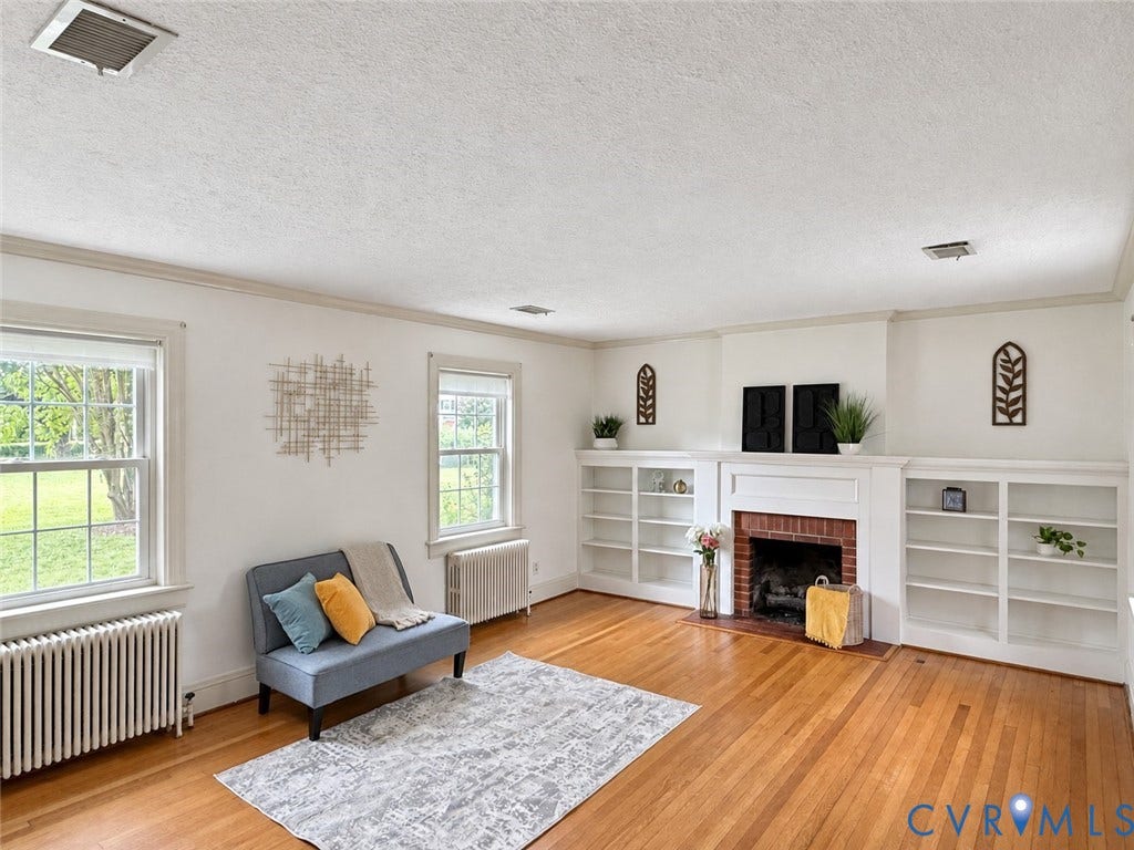 518 Central Terrace, Hopewell, VA 23860 Hardwood flooring, two large windows, white crown molding, brick fireplace, and built-in shelving