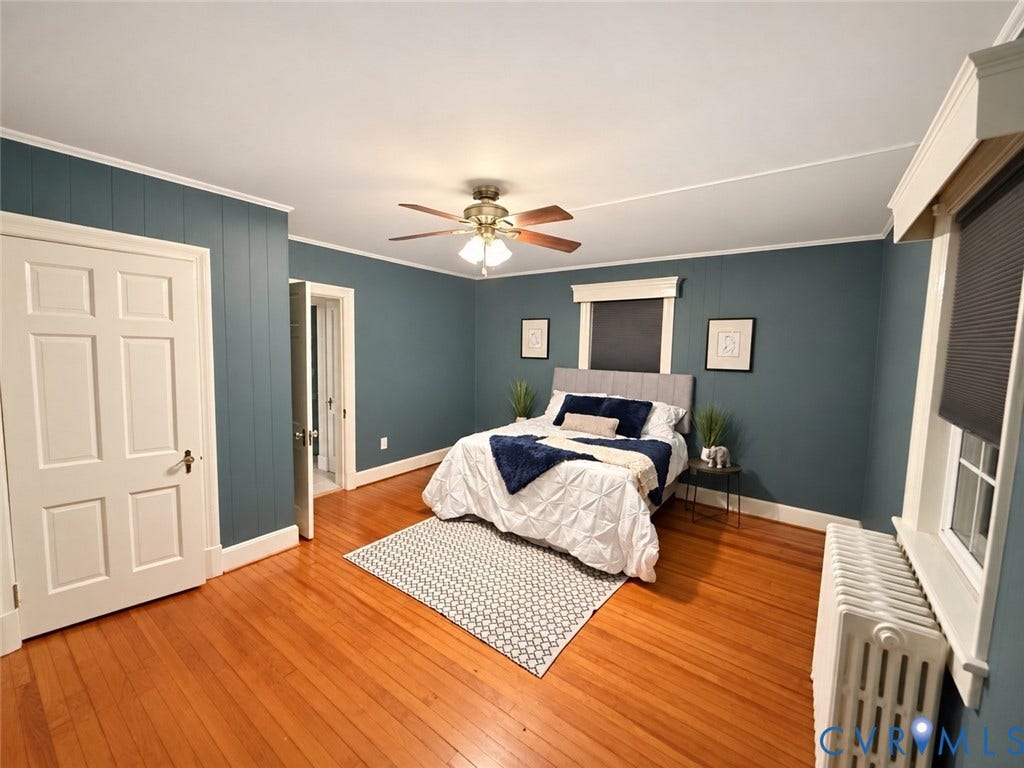 518 Central Terrace, Hopewell, VA 23860 Hardwood flooring, painted paneled accent wall, ceiling fan, window with roller shade, and a radiator