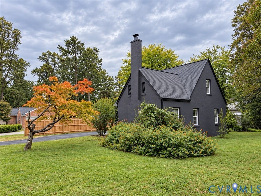 518 Central Terrace, Hopewell, VA 23860 Dark-painted exterior with a prominent chimney, a gabled roof, and white-framed windows
