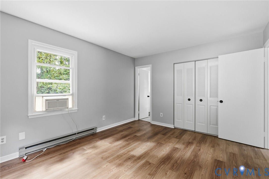 5571 Heatherhill Drive, Whale Rock, North Chesterfield, VA 23234 Wood-finish flooring, white trim, and light gray walls