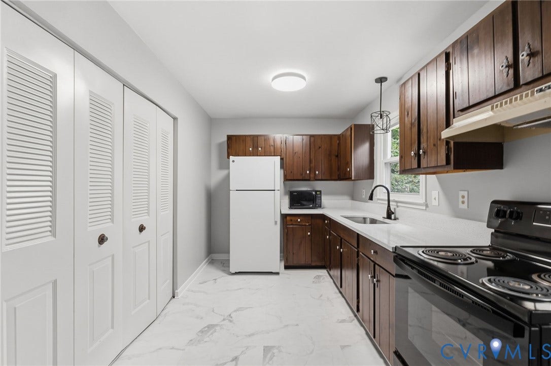 5571 Heatherhill Drive, Whale Rock, North Chesterfield, VA 23234 Kitchen featuring wood cabinetry, white countertops, black appliances, and white louvered closet doors