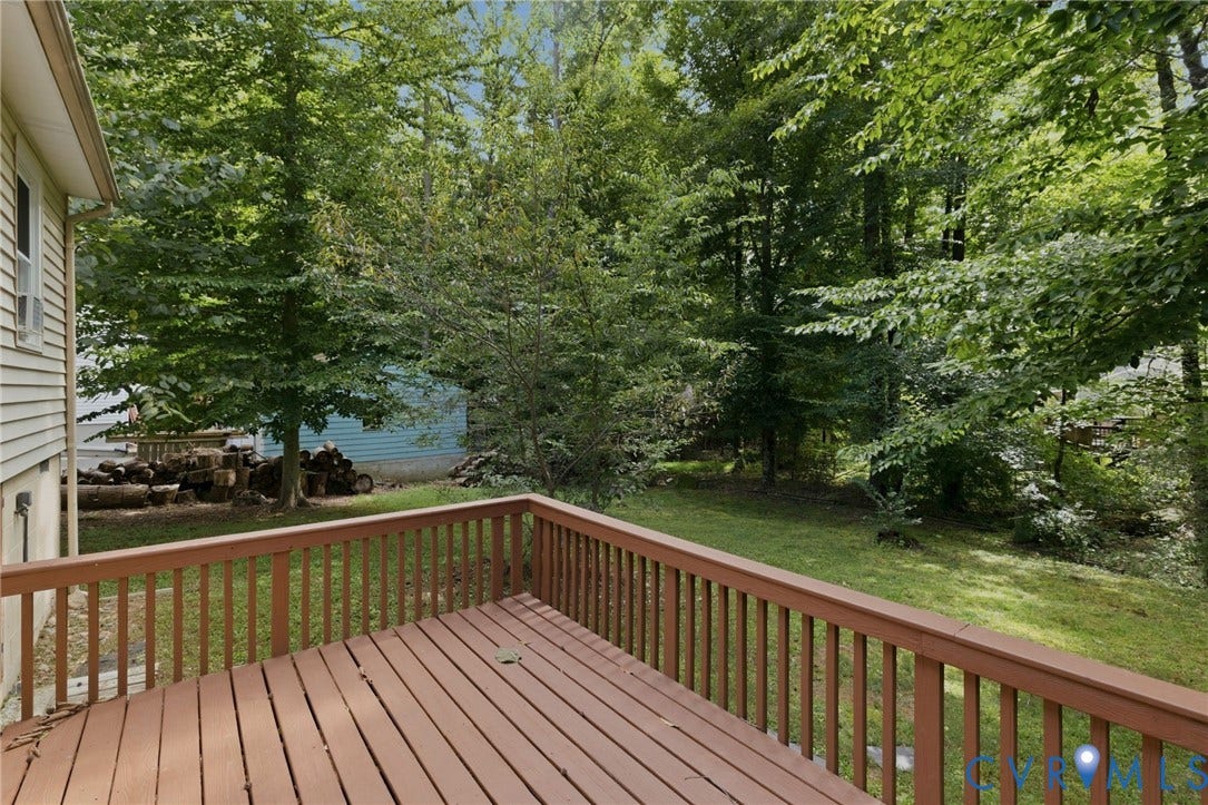 5571 Heatherhill Drive, Whale Rock, North Chesterfield, VA 23234 Expansive wood deck with a full railing, overlooking a green yard and mature trees