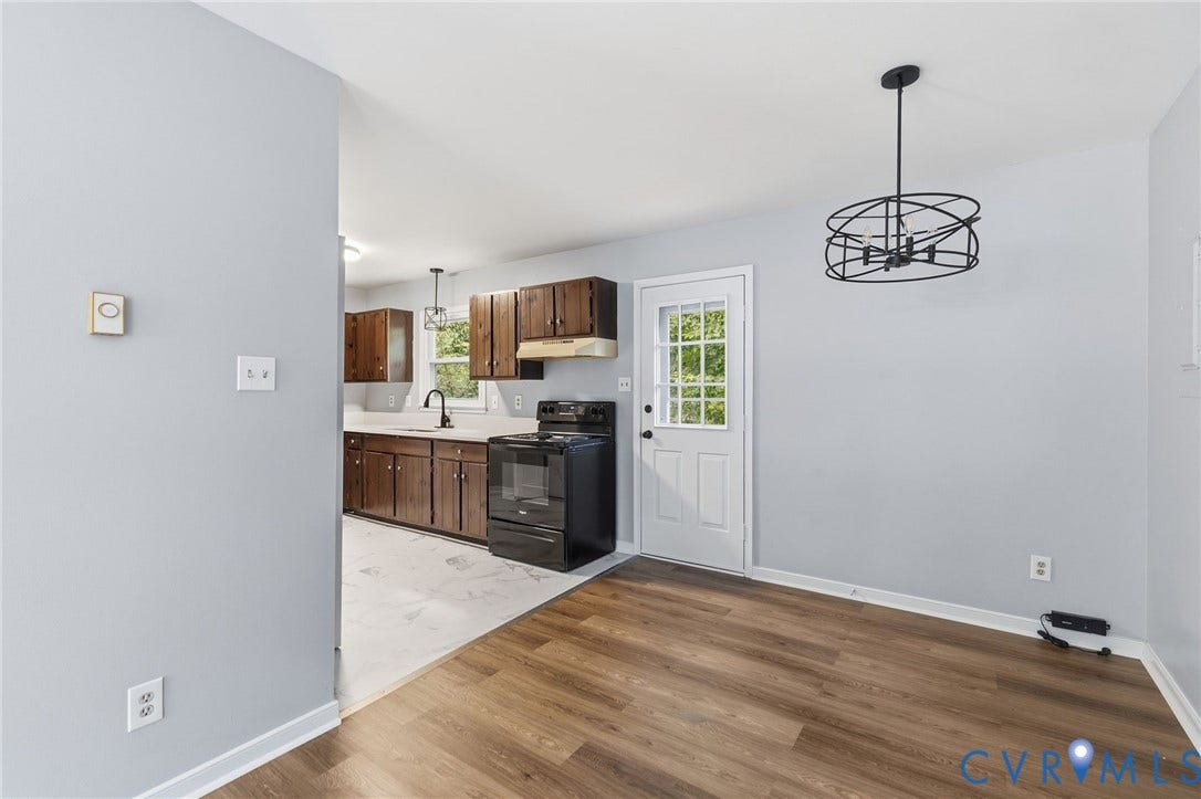 5571 Heatherhill Drive, Whale Rock, North Chesterfield, VA 23234 Wood-finish flooring with a modern black chandelier
