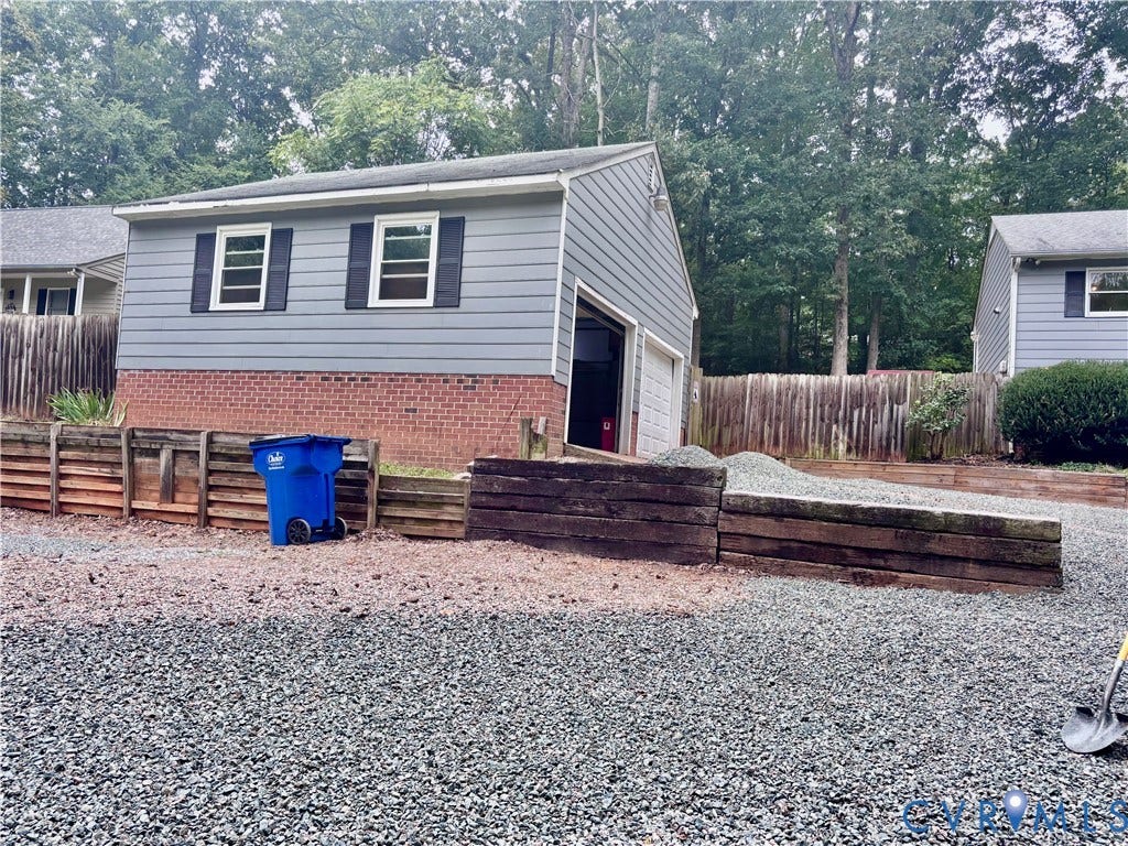 2109 Autumn Oaks Lane, Powhatan, VA 23139 Detached structure with siding and brick veneer, two windows with shutters, and an overhead garage door