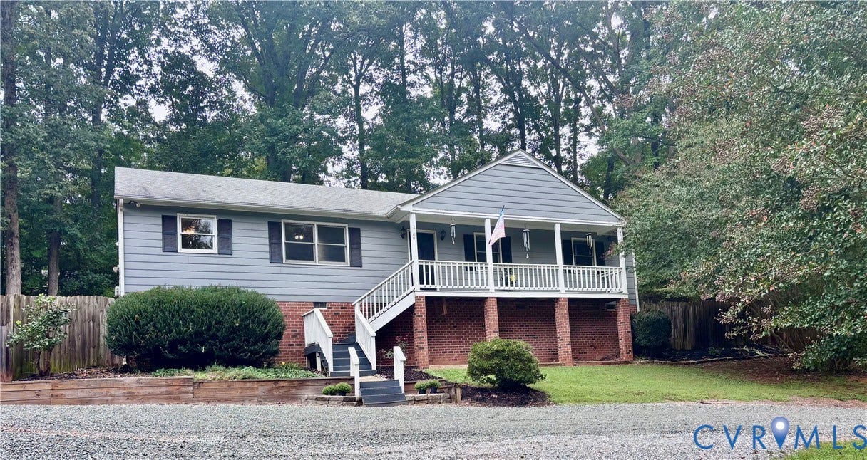 2109 Autumn Oaks Lane, Powhatan, VA 23139 Split-level residence featuring gray siding and a covered front porch with white railings