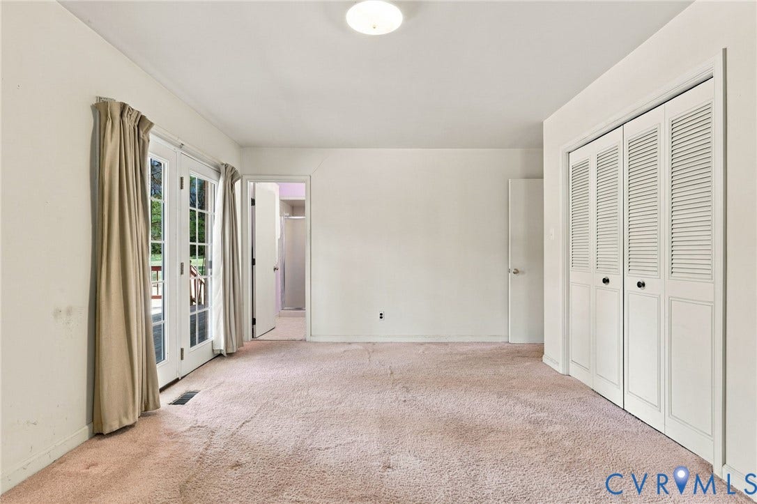 Primary bedroom w/doors to deck and ensuite bath